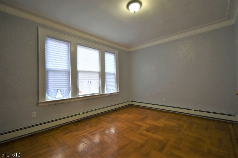 352 Wainwright Street, Unit 1L Newark, NJ 07112 - Photo 3 of 11 an empty room with a empty space and a window