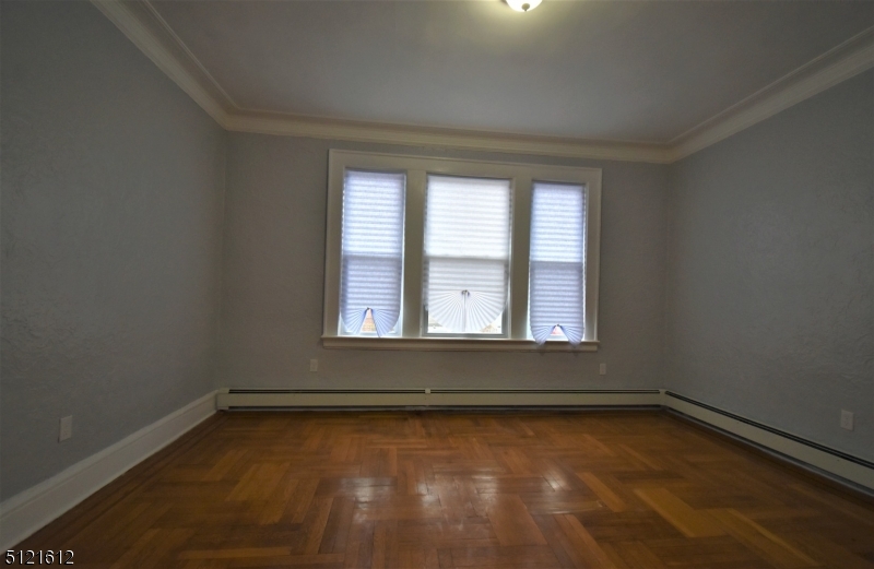 352 Wainwright Street, Unit 1L Newark, NJ 07112 - Photo 4 of 11 an empty room with a window