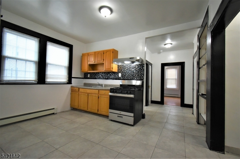 352 Wainwright Street, Unit 1L Newark, NJ 07112 - Photo 8 of 11 a kitchen with stainless steel appliances a stove a sink and a refrigerator