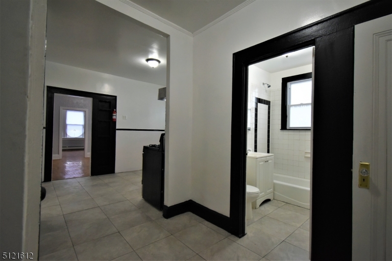 352 Wainwright Street, Unit 1L Newark, NJ 07112 - Photo 9 of 11 a view of a hallway with some storage and utility room