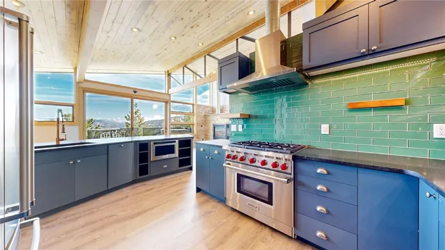 a kitchen with stainless steel appliances granite countertop a stove and a sink