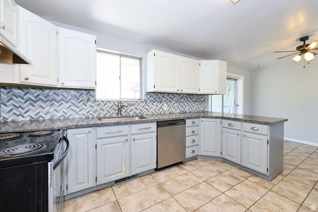 1272 Cook Street Ogden, UT 84404 - Photo 10 of 46 Kitchen featuring white upper cabinetry, grey lower cabinetry, a chevron-patterned tile backsplash, granite-finish countertops, and a built-in stainless steel dishwasher
