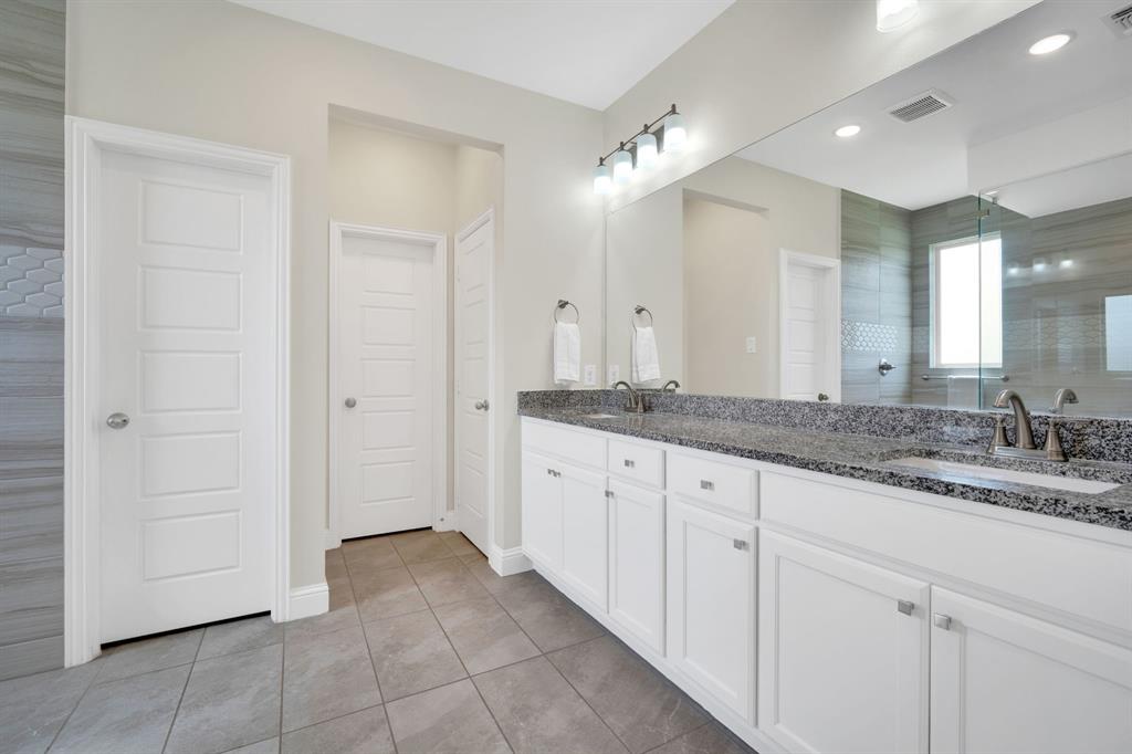 1601 Bear Path Way Gunter, TX 75058 - Photo 23 of 40 a bathroom with a granite countertop sink and a mirror