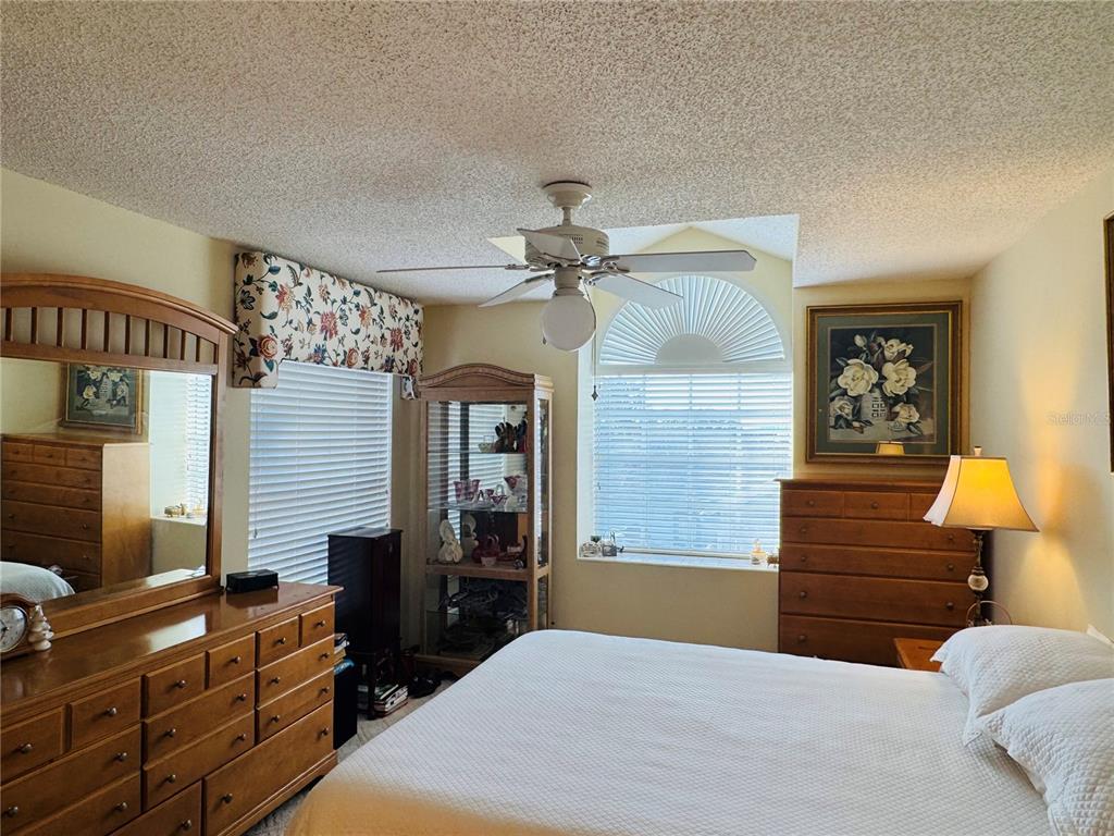 240 Division Street Clermont, FL 34711 - Photo 12 of 16 a bedroom with a bed and wooden floor