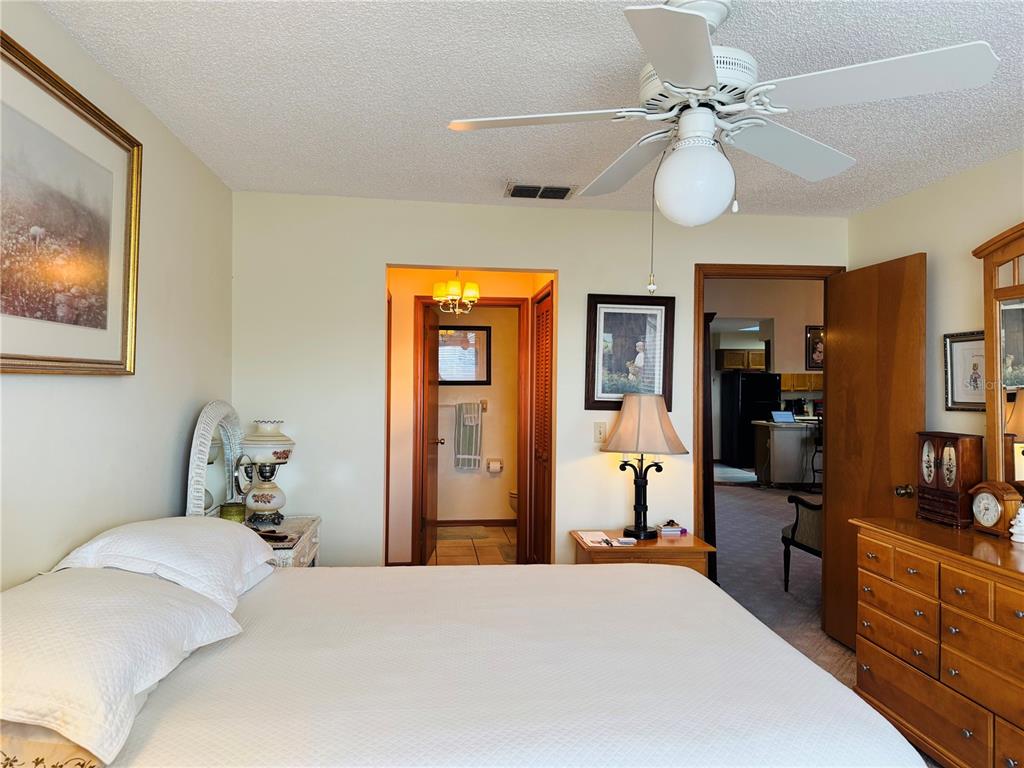 240 Division Street Clermont, FL 34711 - Photo 13 of 16 a bedroom with a bed and wooden floor