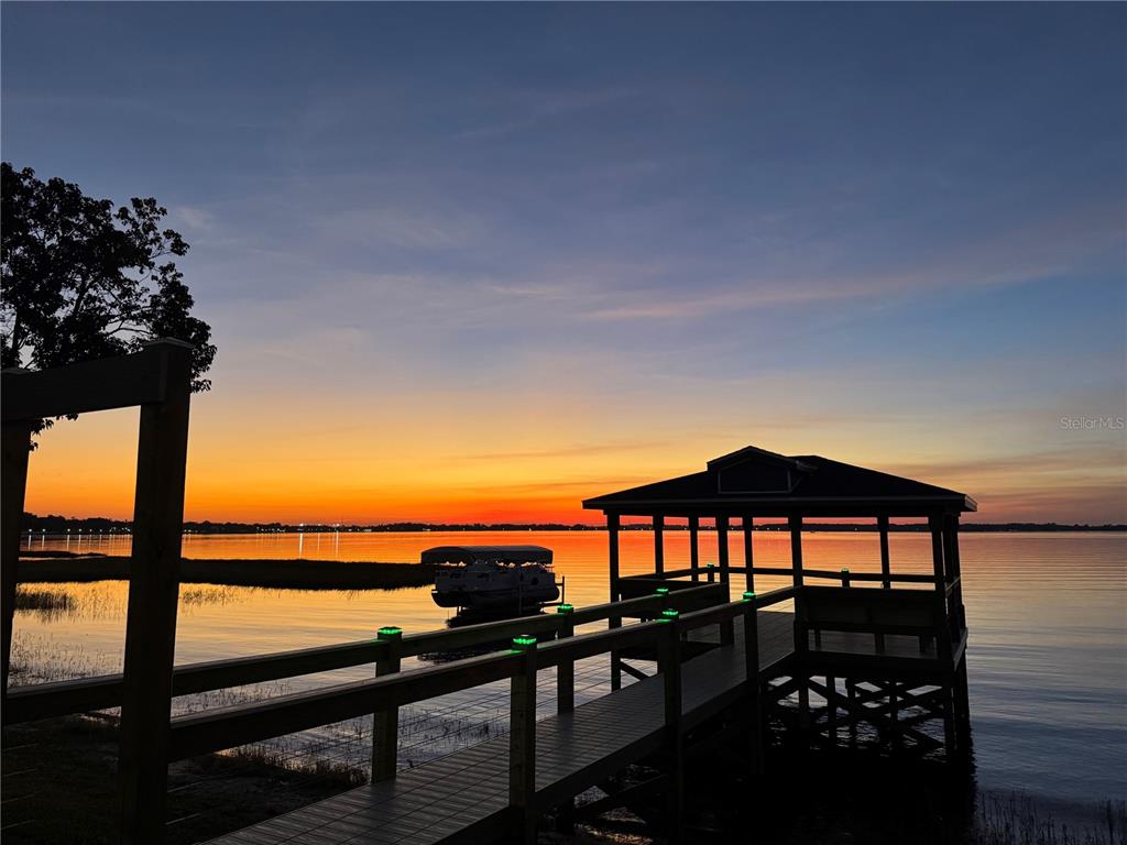 240 Division Street Clermont, FL 34711 - Photo 3 of 16 a view of a balcony with chairs and a potted plant