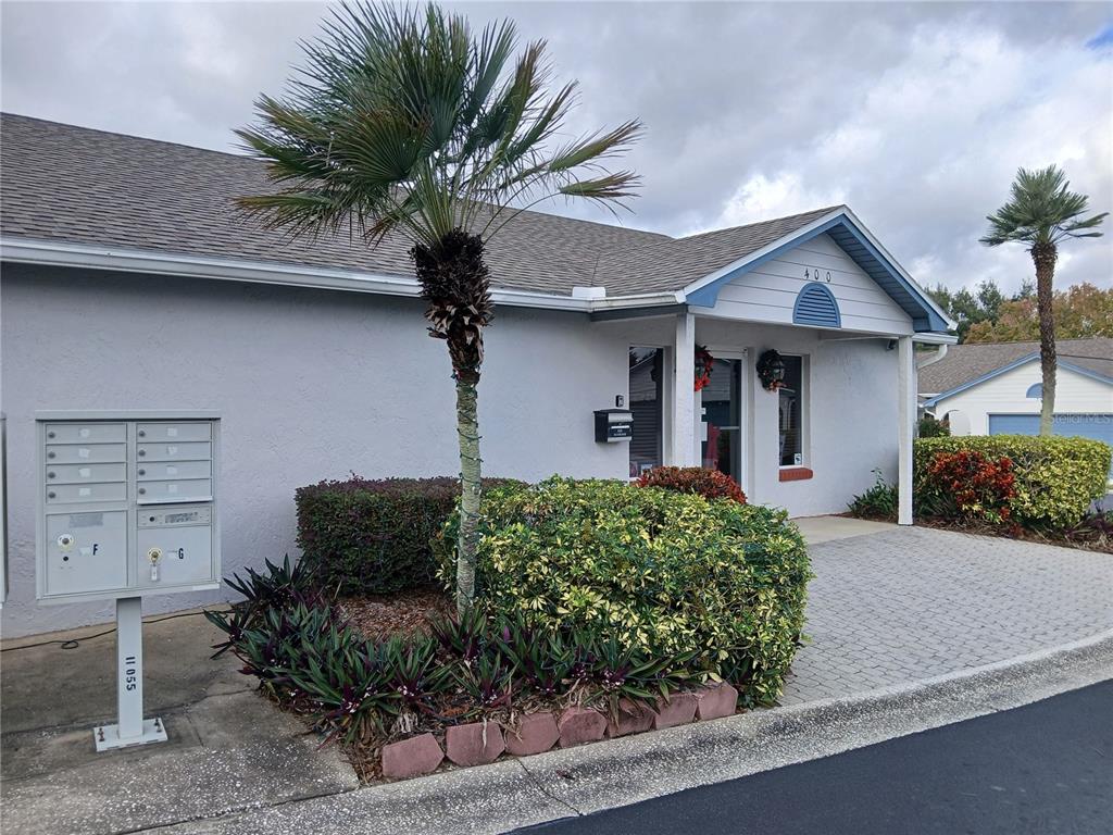 240 Division Street Clermont, FL 34711 - Photo 6 of 16 a front view of a house with a yard and garage