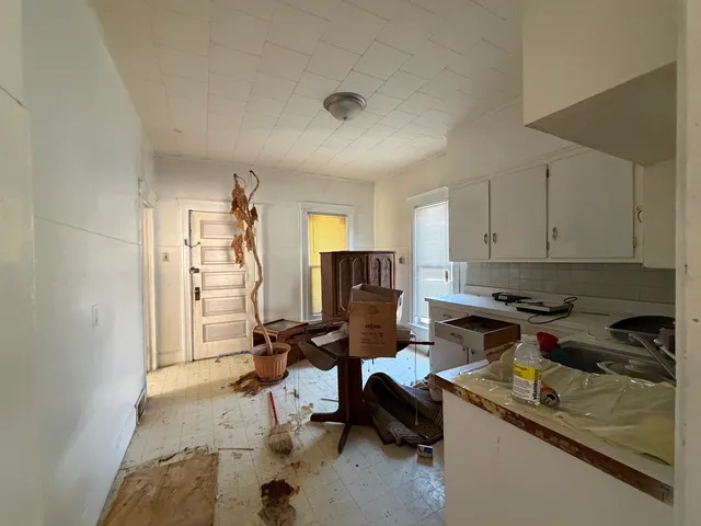 a view of a kitchen with refrigerator and a stove