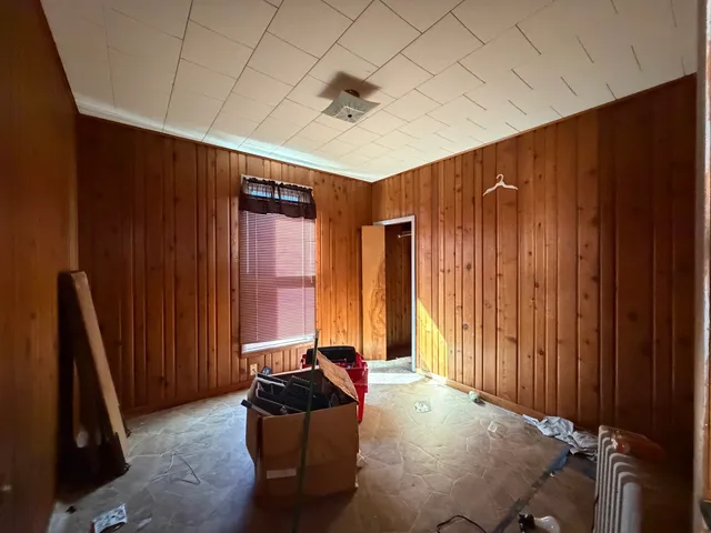 a living room with furniture a window and a wooden door