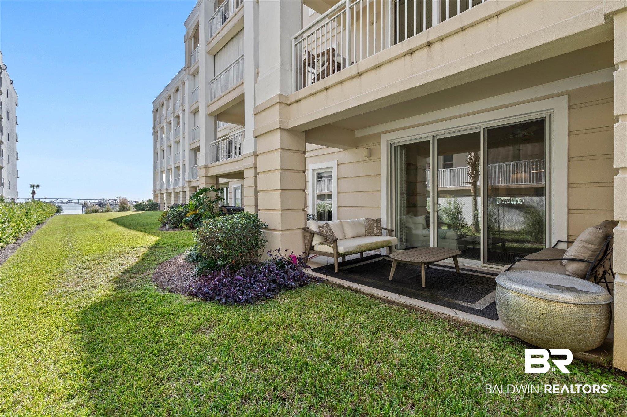 27770 Canal Road, Unit 2102 Orange Beach, AL 36561 - Photo 13 of 19 Surrounding community featuring a lawn and a balcony