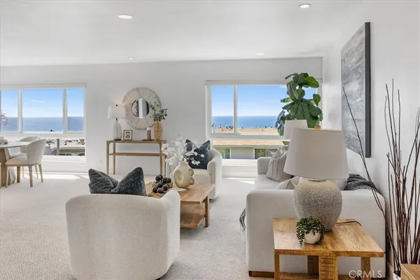 a living room with furniture a potted plant and a fireplace