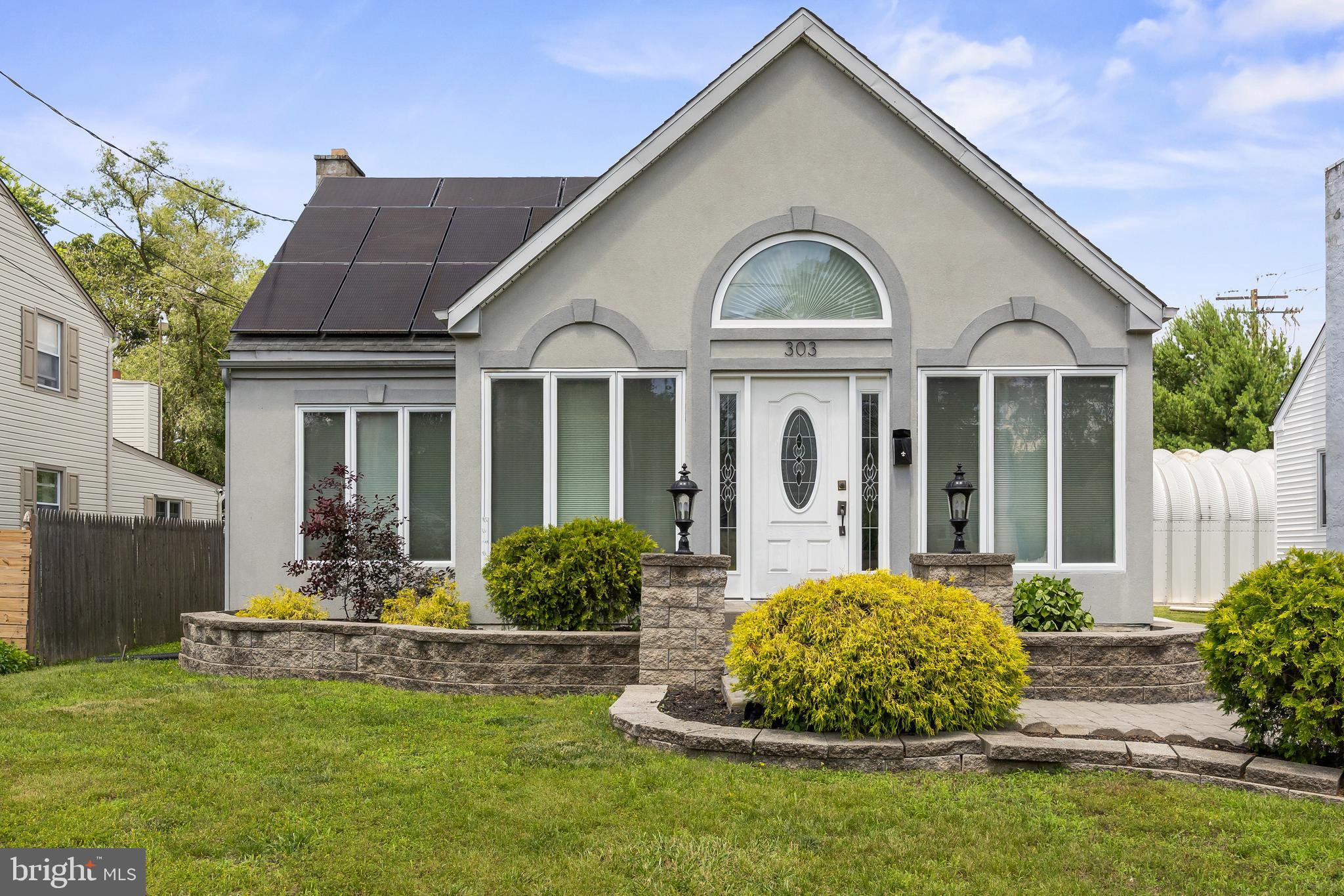 303 Cornell Road Glassboro, NJ 08028 - Photo 1 of 27 a front view of a house with a garden and plants