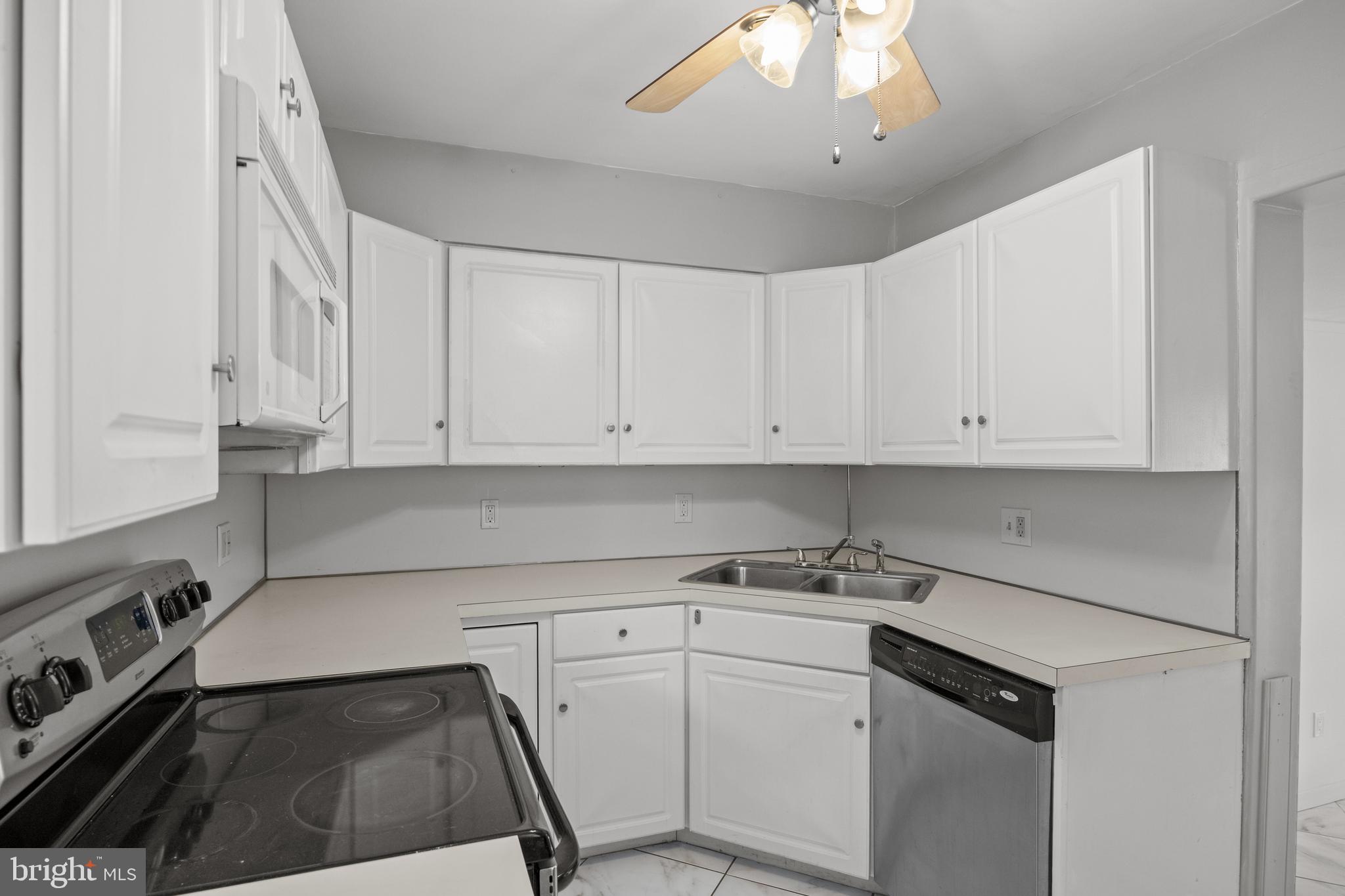 303 Cornell Road Glassboro, NJ 08028 - Photo 14 of 27 a kitchen with white cabinets and white appliances