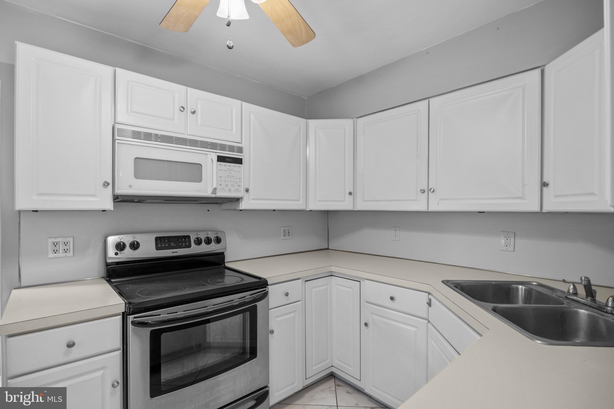 303 Cornell Road Glassboro, NJ 08028 - Photo 16 of 27 a kitchen with granite countertop white cabinets white stainless steel appliances and sink