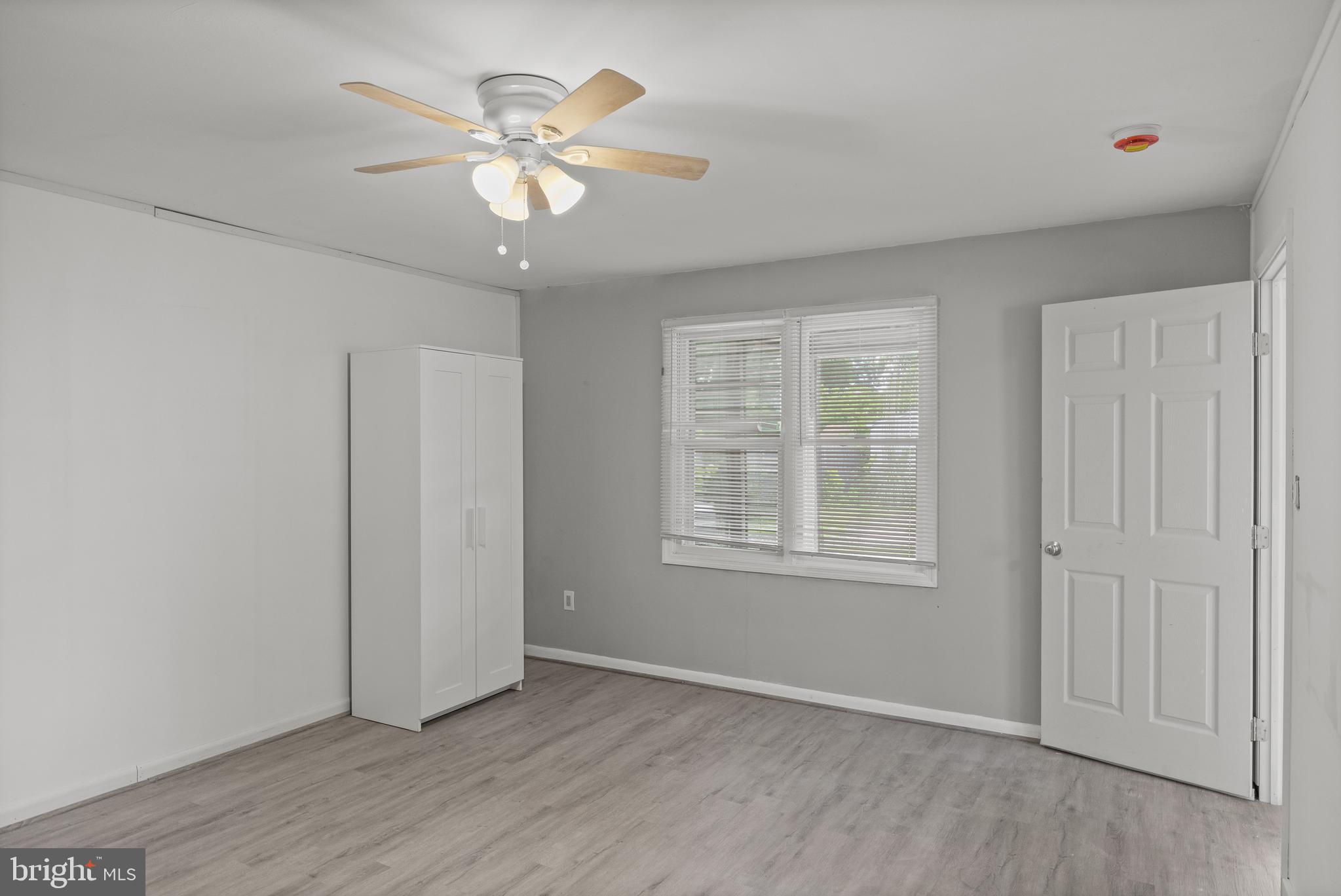 303 Cornell Road Glassboro, NJ 08028 - Photo 20 of 27 a view of an empty room with wooden floor and a window
