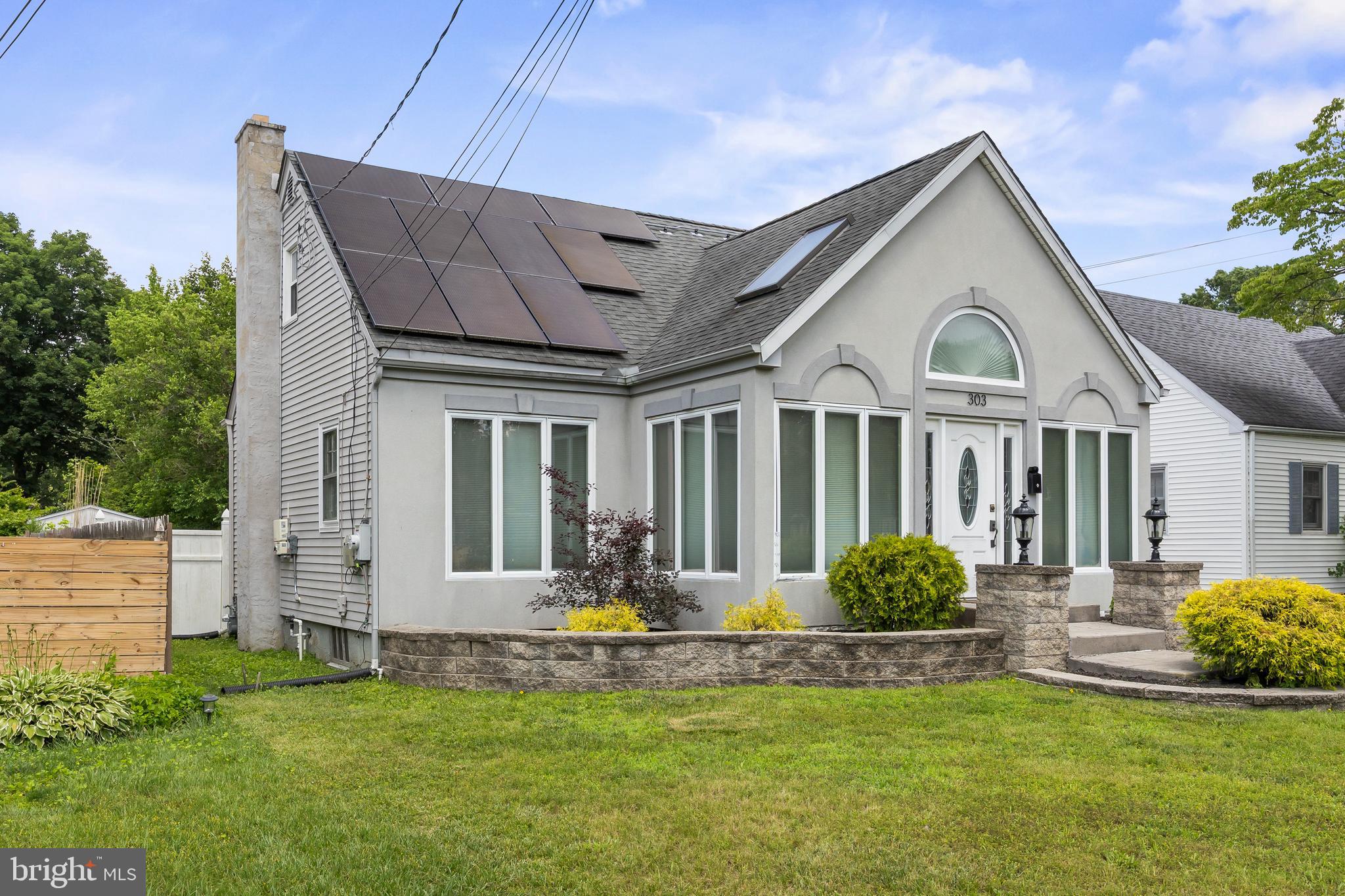 303 Cornell Road Glassboro, NJ 08028 - Photo 2 of 27 a front view of a house with a garden and plants