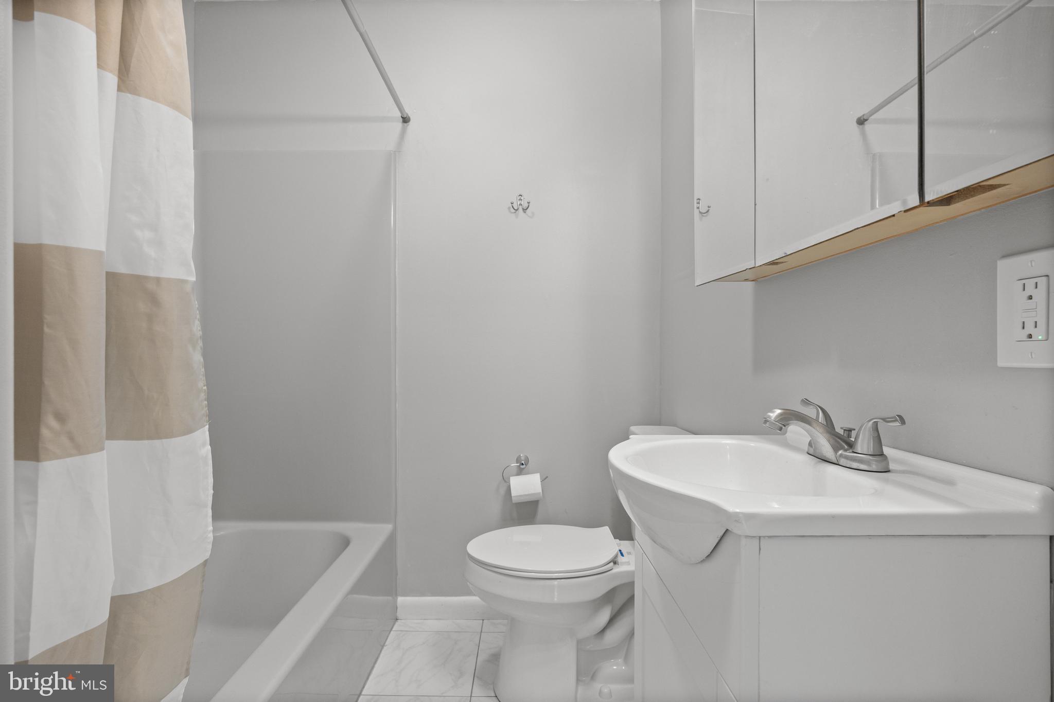 303 Cornell Road Glassboro, NJ 08028 - Photo 9 of 27 a bathroom with a sink a toilet and shower