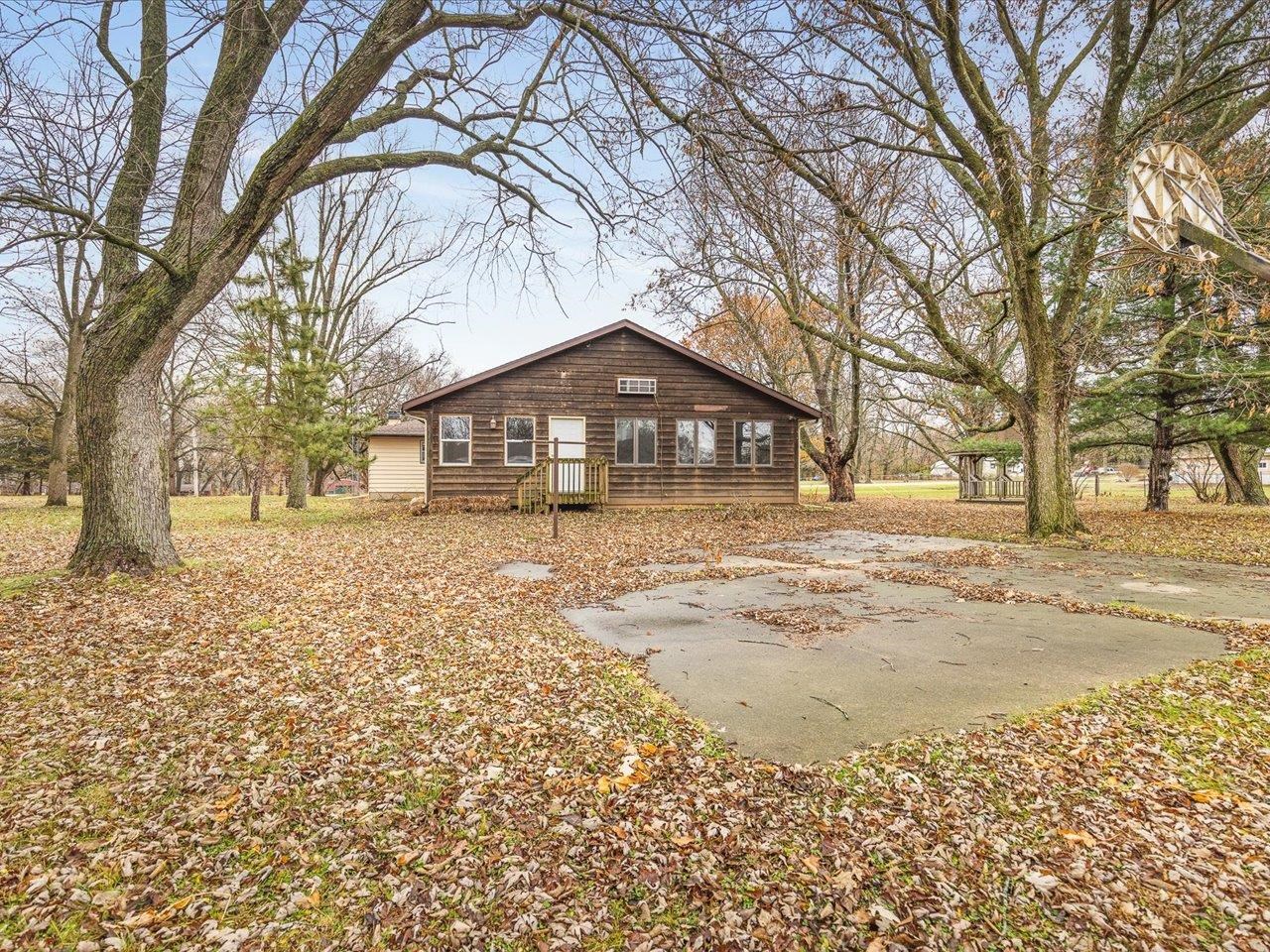 7774 Old River Road Rockford, IL 61103 - Photo 18 of 53 a front view of a house with a yard covered with snow