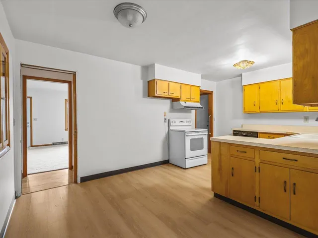 a kitchen with a sink cabinets stainless steel appliances and a window