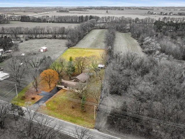an aerial view of a house with a yard