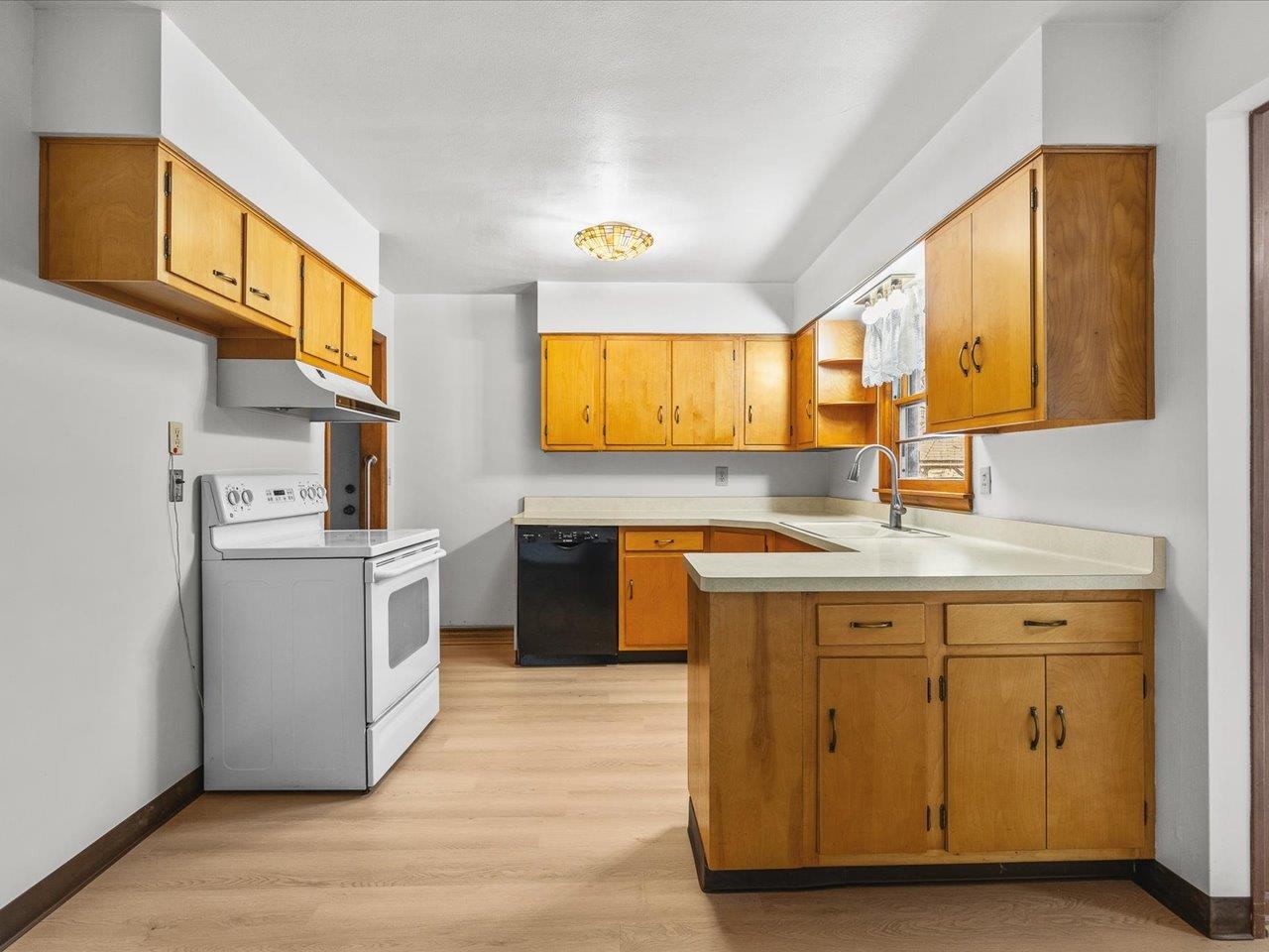 7774 Old River Road Rockford, IL 61103 - Photo 22 of 53 a kitchen with a sink cabinets stainless steel appliances and a window