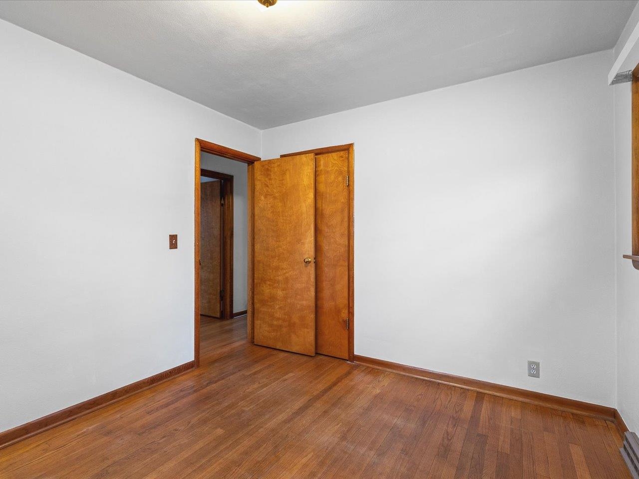 7774 Old River Road Rockford, IL 61103 - Photo 29 of 53 a view of an empty room with wooden floor and a window