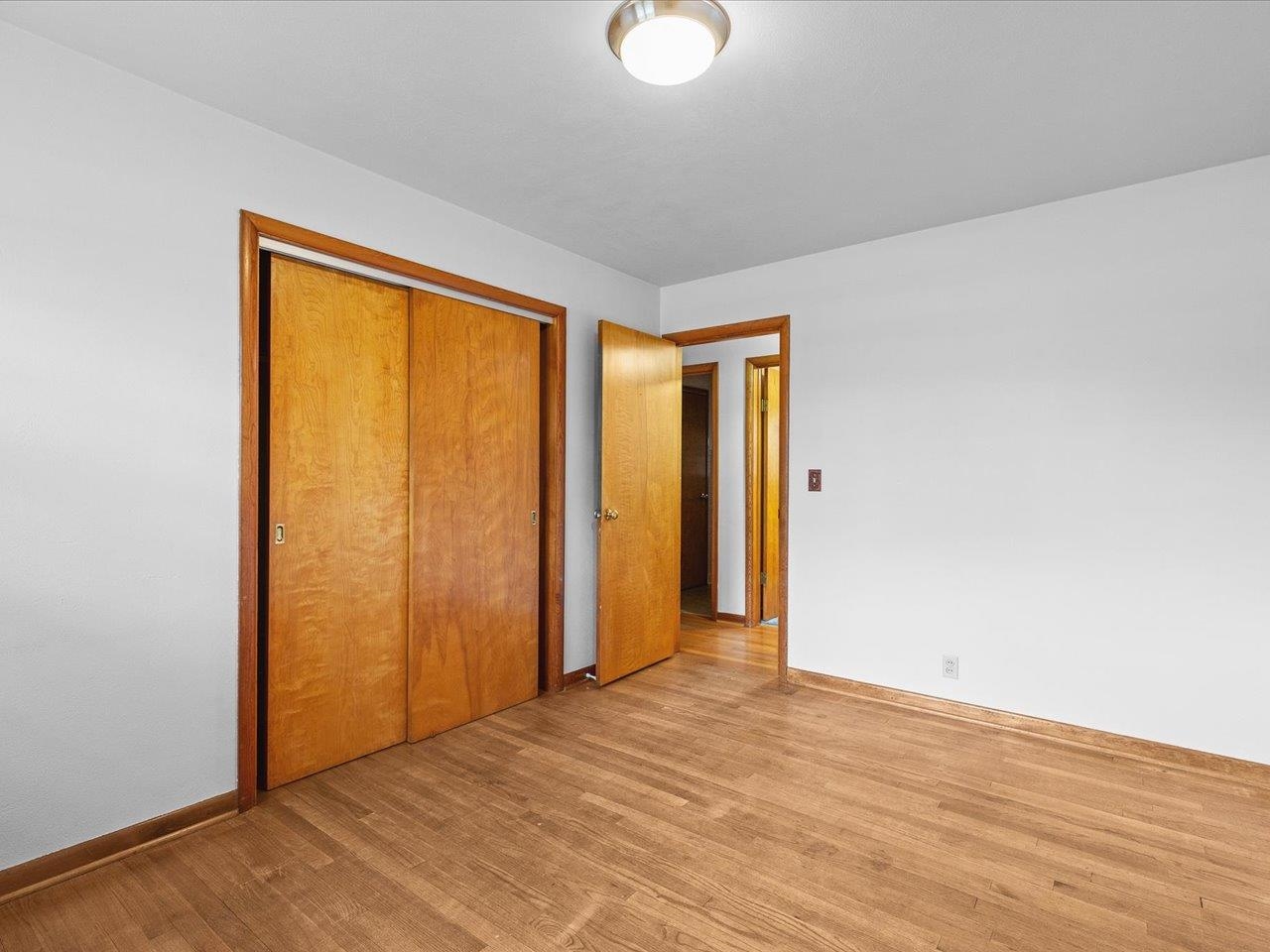 7774 Old River Road Rockford, IL 61103 - Photo 30 of 53 a view of an empty room with wooden floor and a window