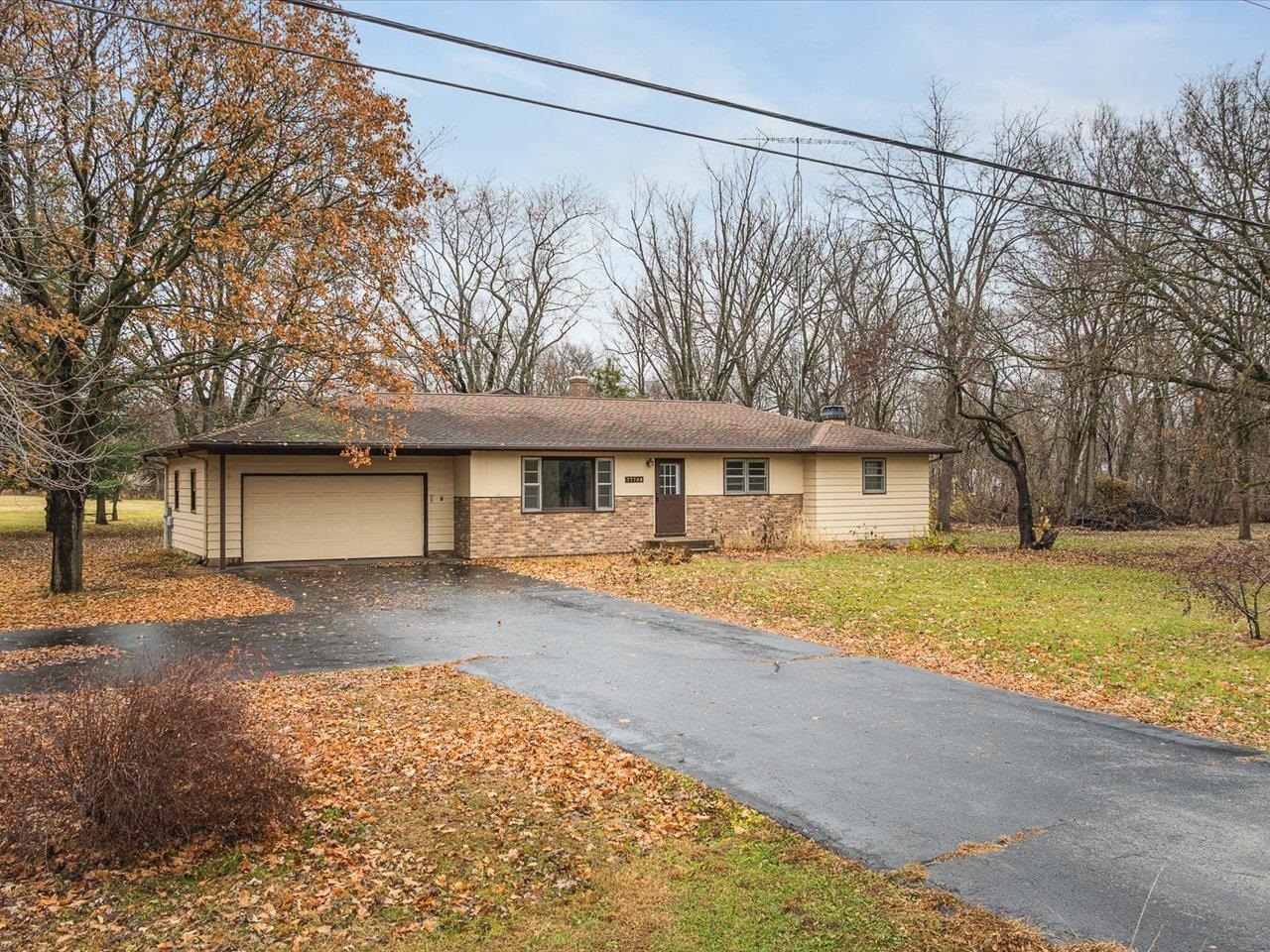 7774 Old River Road Rockford, IL 61103 - Photo 53 of 53 a front view of a house with a yard and garage