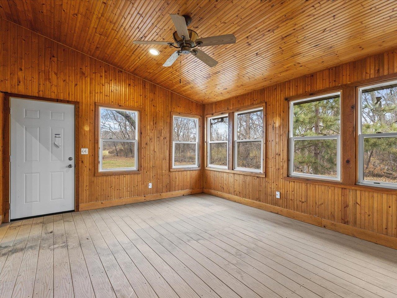 7774 Old River Road Rockford, IL 61103 - Photo 10 of 53 a view of an empty room with a window and wooden floor