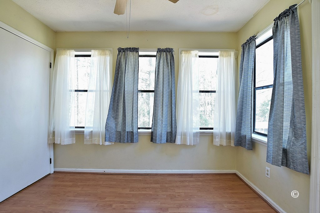 6321 Milgen Road, Unit 4 Columbus, GA 31907 - Photo 14 of 16 Sunroom, with laundry room adjacent.