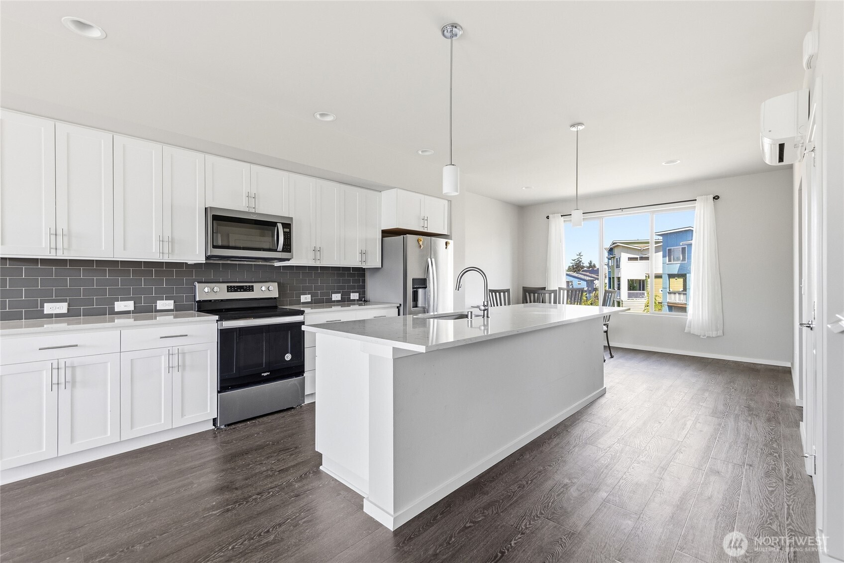 1066 Southwest 99th Place, Unit 55 Seattle, WA 98106 - Photo 21 of 21 a large kitchen with stainless steel appliances granite countertop a stove a sink dishwasher a microwave oven and a refrigerator with wooden floors
