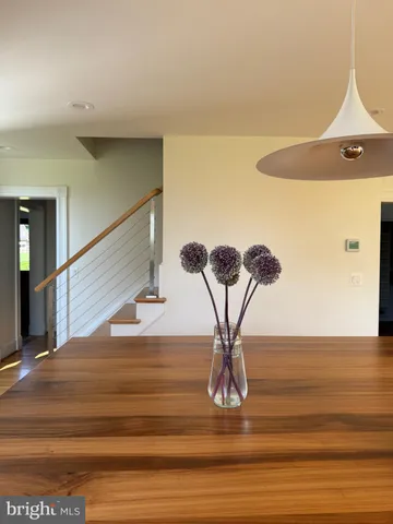 a large white bed sitting in a bedroom next to a lamp