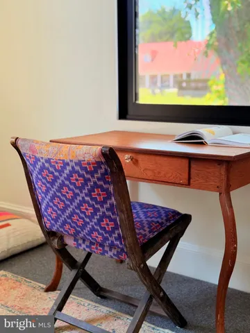 a living room with furniture large window and a fireplace
