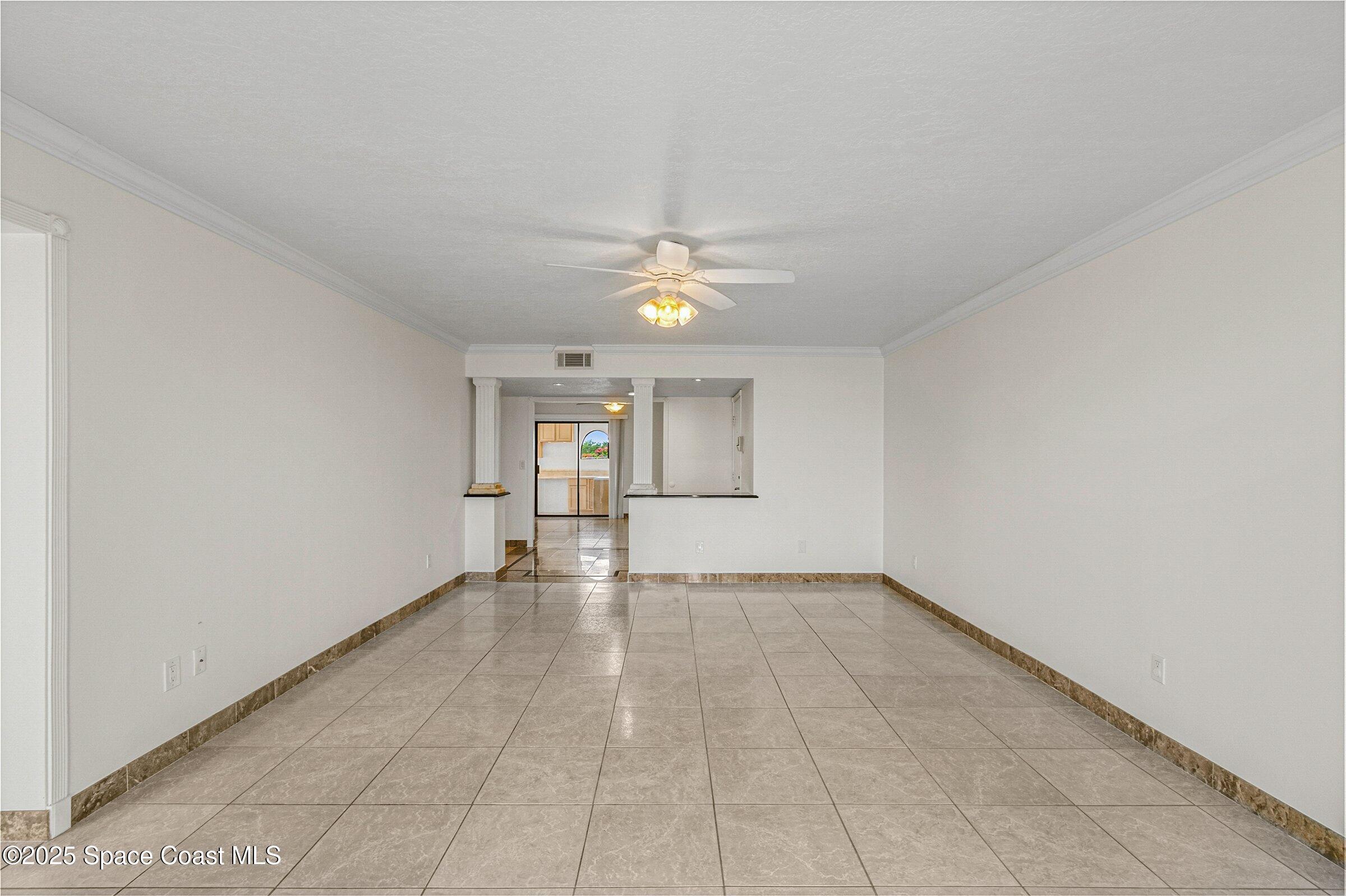 115 Indian River Drive, Unit 327 Cocoa, FL 32922 - Photo 11 of 47 an empty room with chandelier fan and windows