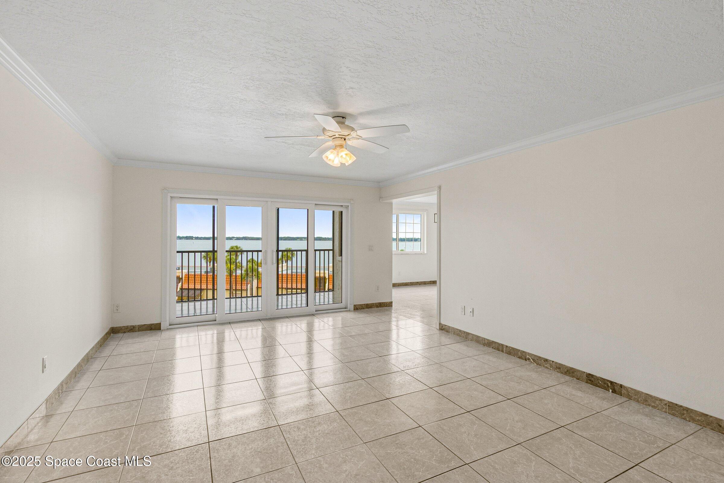 115 Indian River Drive, Unit 327 Cocoa, FL 32922 - Photo 13 of 47 an empty room with windows and ceiling fan