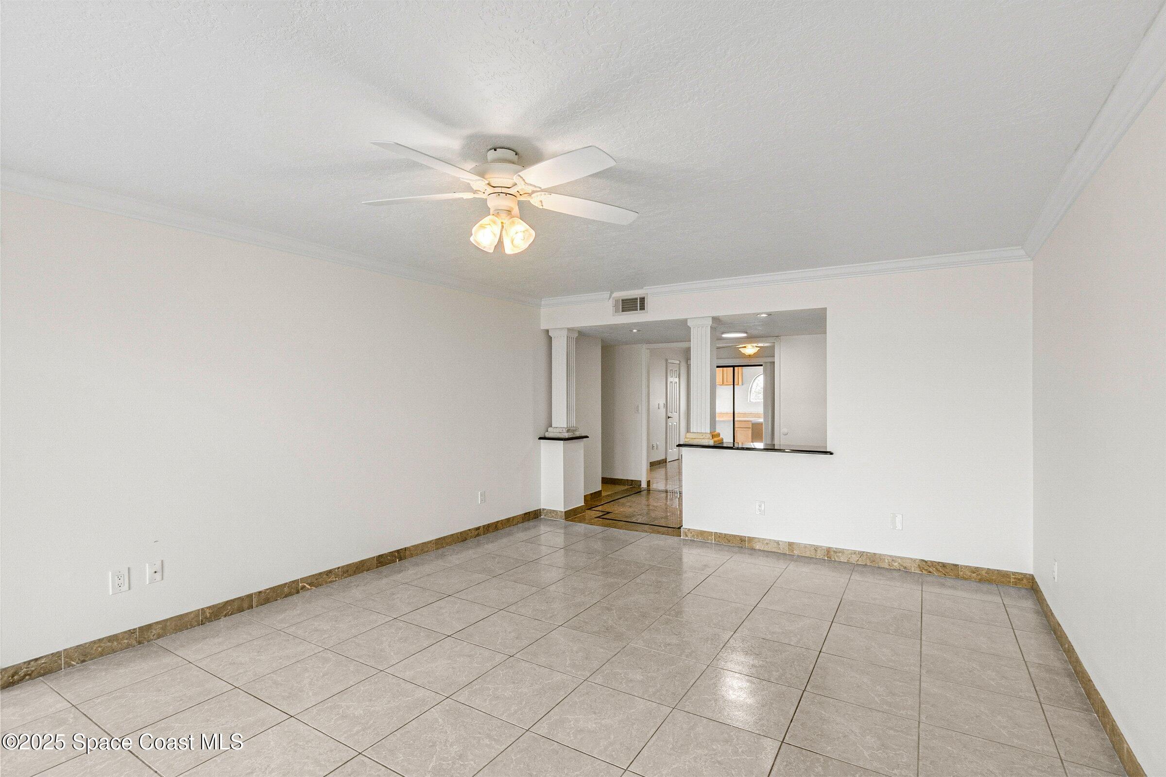 115 Indian River Drive, Unit 327 Cocoa, FL 32922 - Photo 14 of 47 an empty room with fan and windows