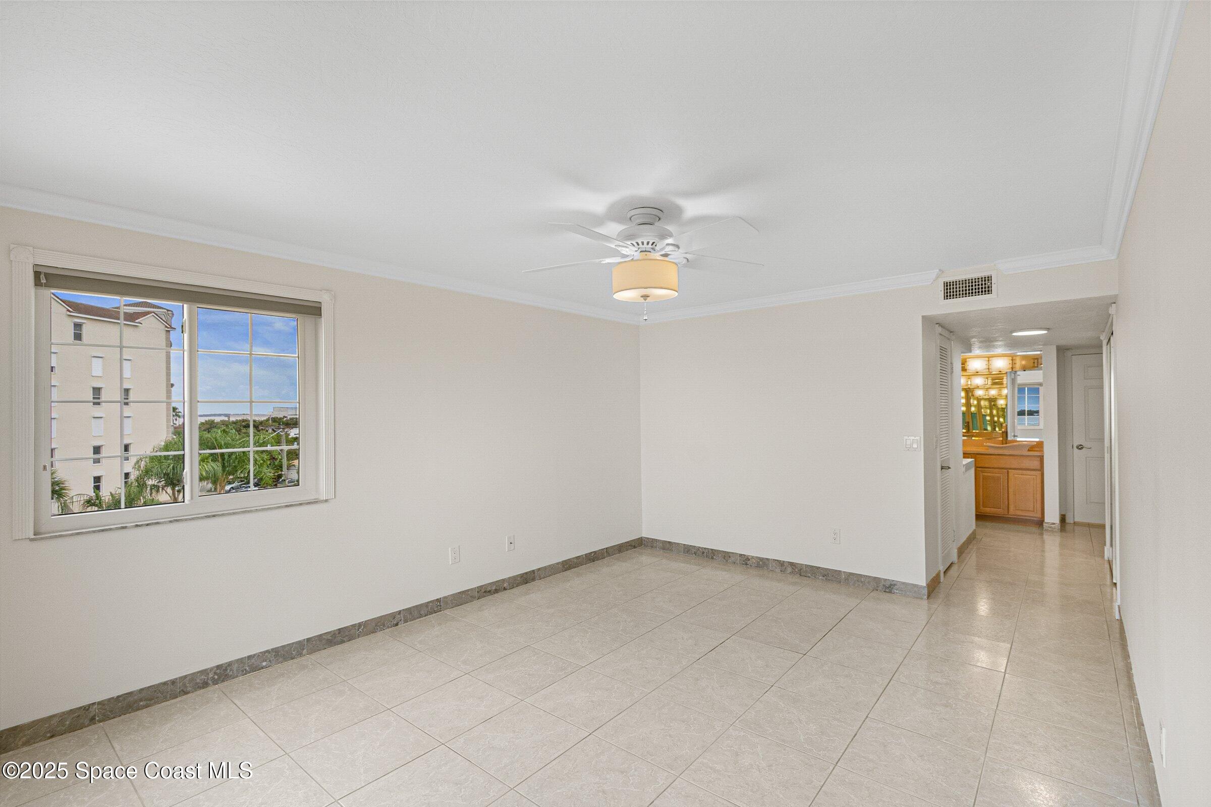 115 Indian River Drive, Unit 327 Cocoa, FL 32922 - Photo 17 of 47 an empty room with windows and chandelier fan