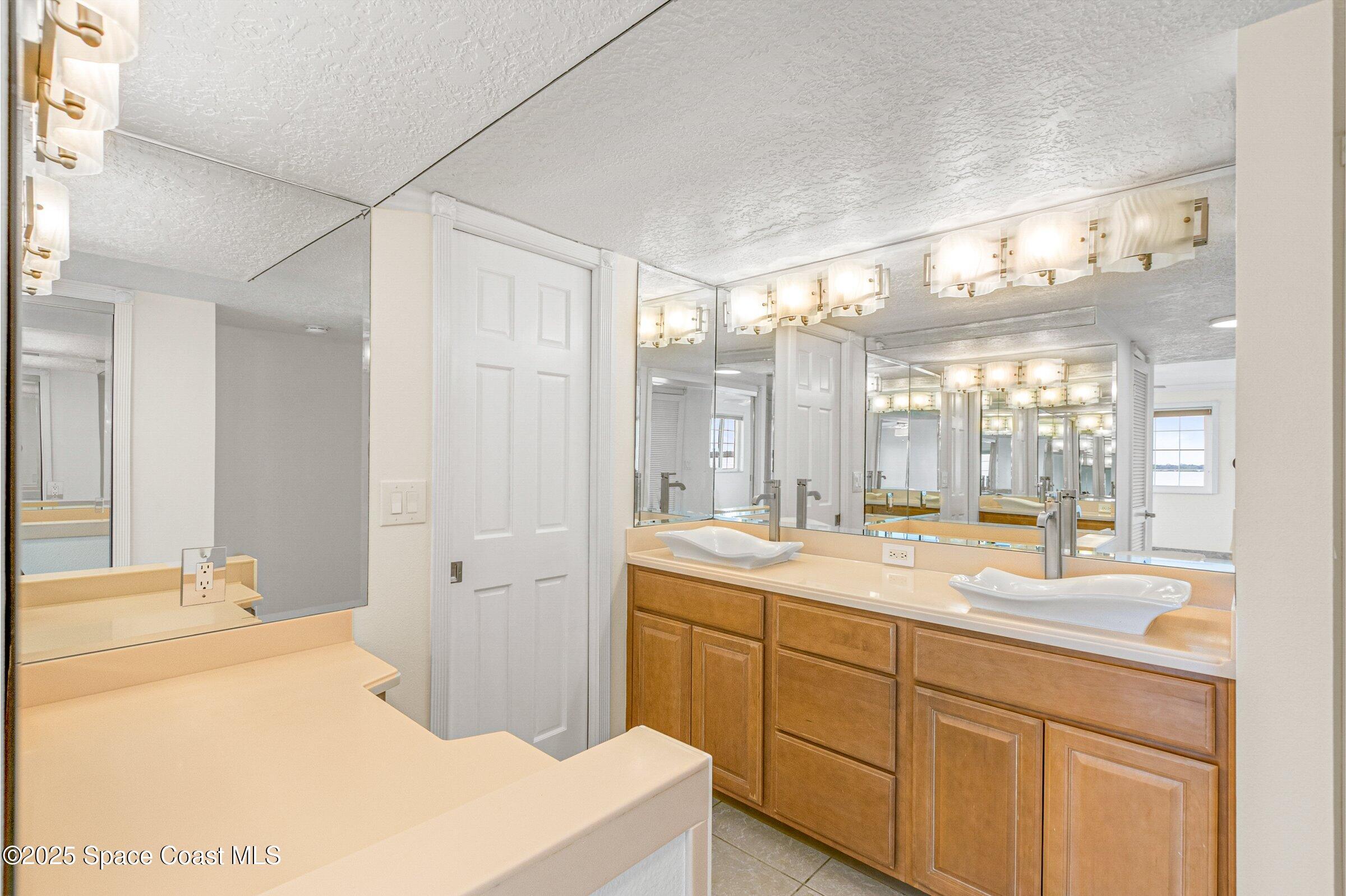 115 Indian River Drive, Unit 327 Cocoa, FL 32922 - Photo 19 of 47 a spacious bathroom with a double vanity sink mirror and