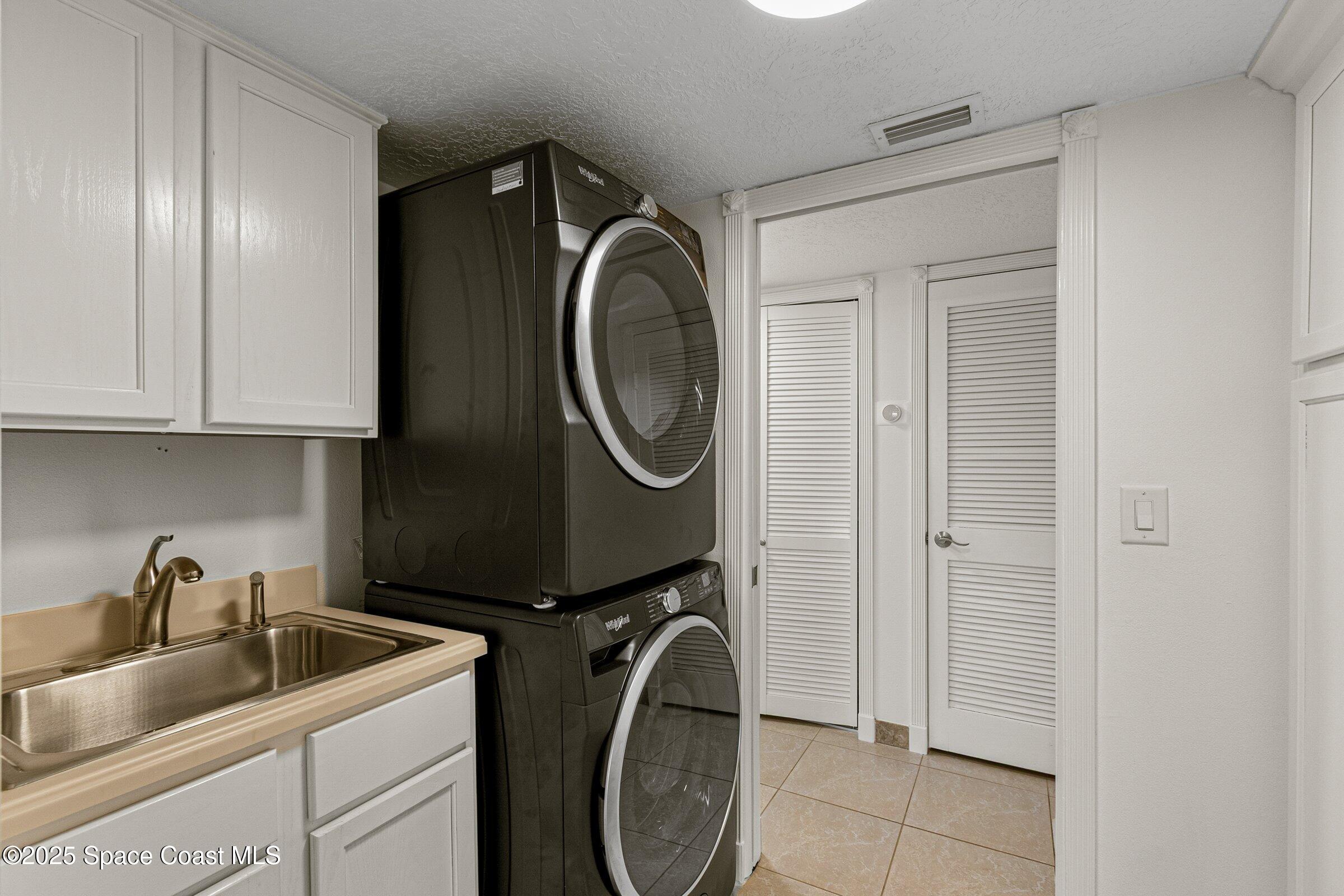 115 Indian River Drive, Unit 327 Cocoa, FL 32922 - Photo 26 of 47 a utility room with sink dryer and washer
