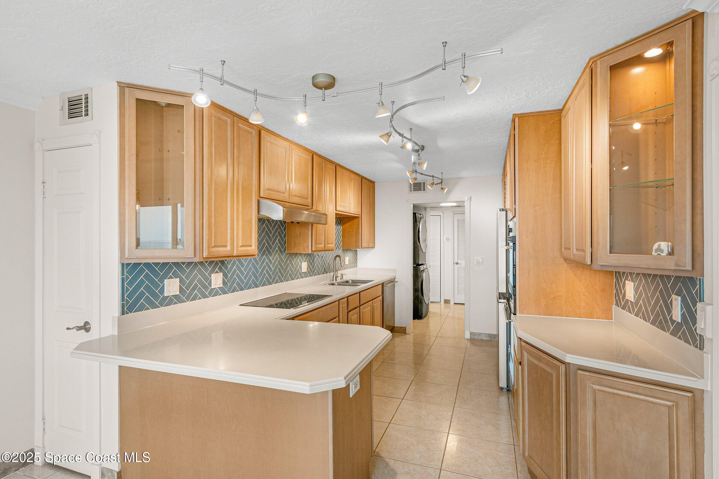 115 Indian River Drive, Unit 327 Cocoa, FL 32922 - Photo 7 of 47 a kitchen with a sink a stove a refrigerator and a window