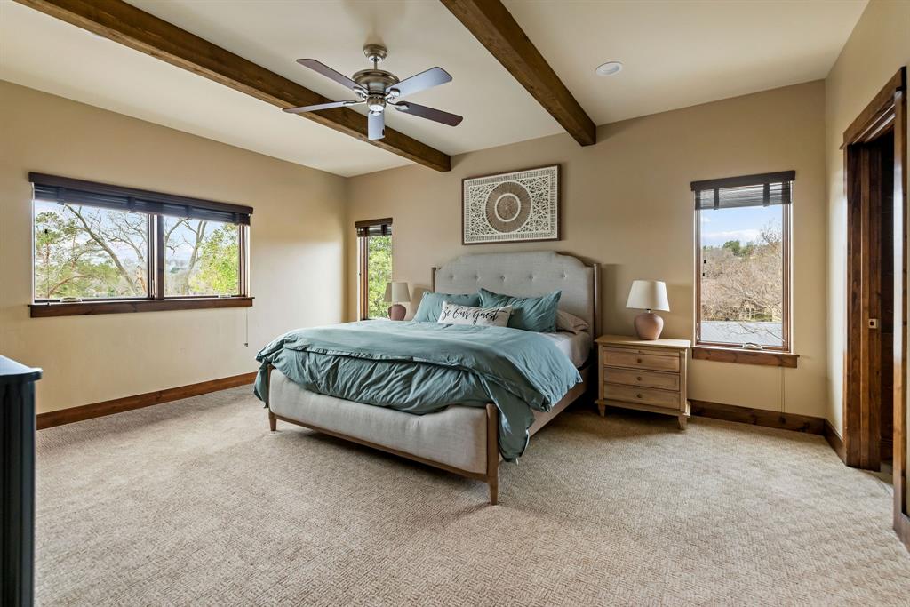 9930 Boat Club Road Fort Worth, TX 76179 - Photo 24 of 40 This upstairs bedroom with en suite in the main residence brings in all the natural window lighting with the elevated views outside!