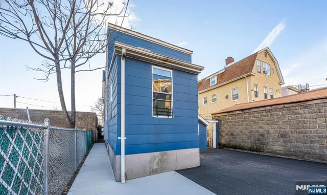 a front view of a house with iron fence