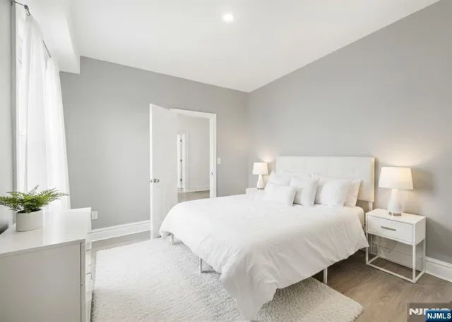 a bedroom with a bed and a potted plant