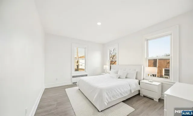 a bedroom with a bed and a large window