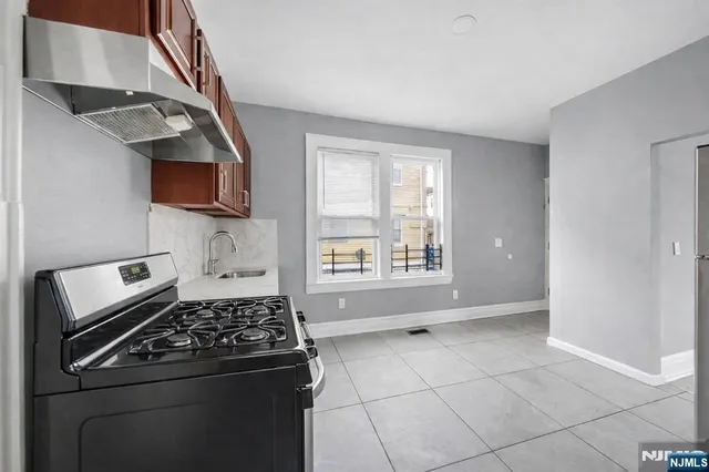 a kitchen with kitchen island a stove a sink and a microwave