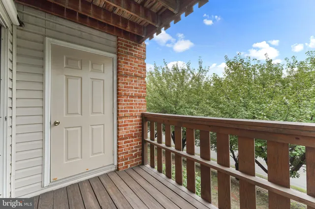a view of a balcony with wooden floor