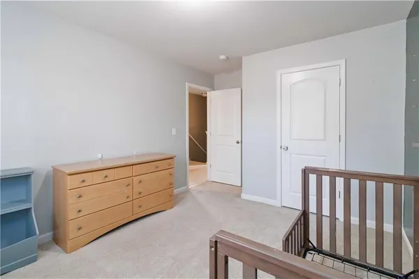 a room with a dresser and a window