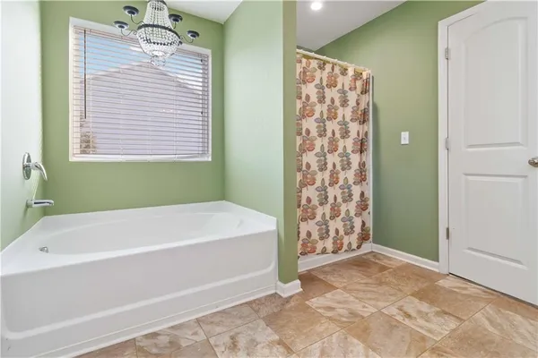 a bathroom with a bathtub and shower