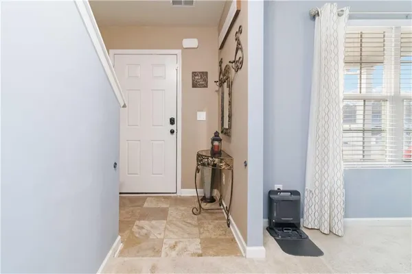 a view of a hallway with closet and bedroom