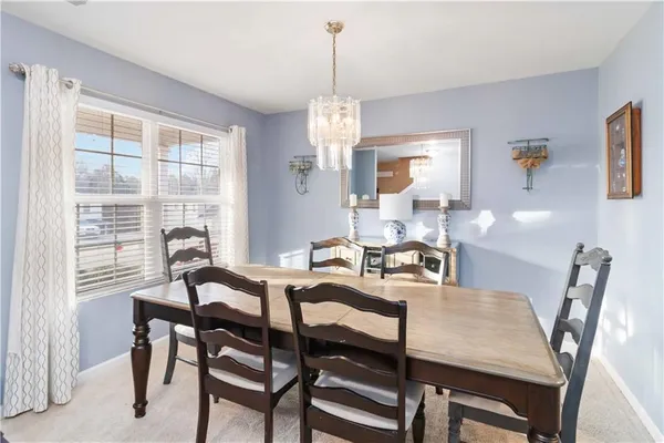a view of a dining room with furniture window and outside view